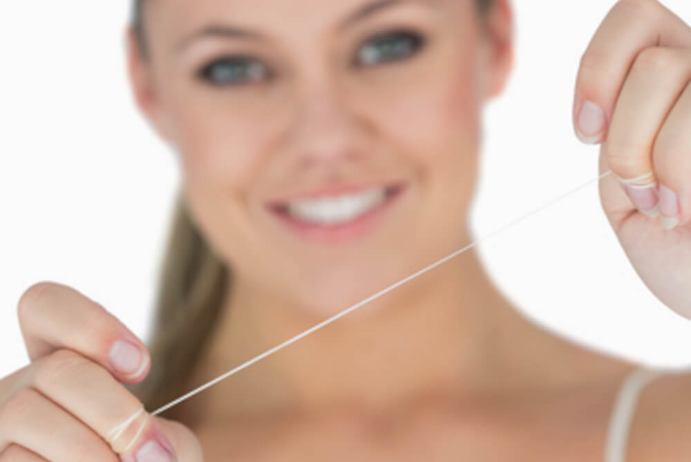 woman holding floss in hand